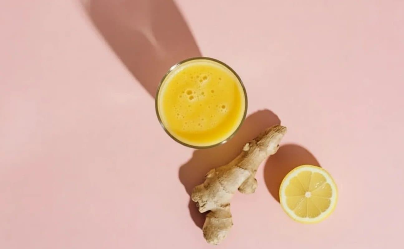 Glasses of ginger and citrus on a pale table